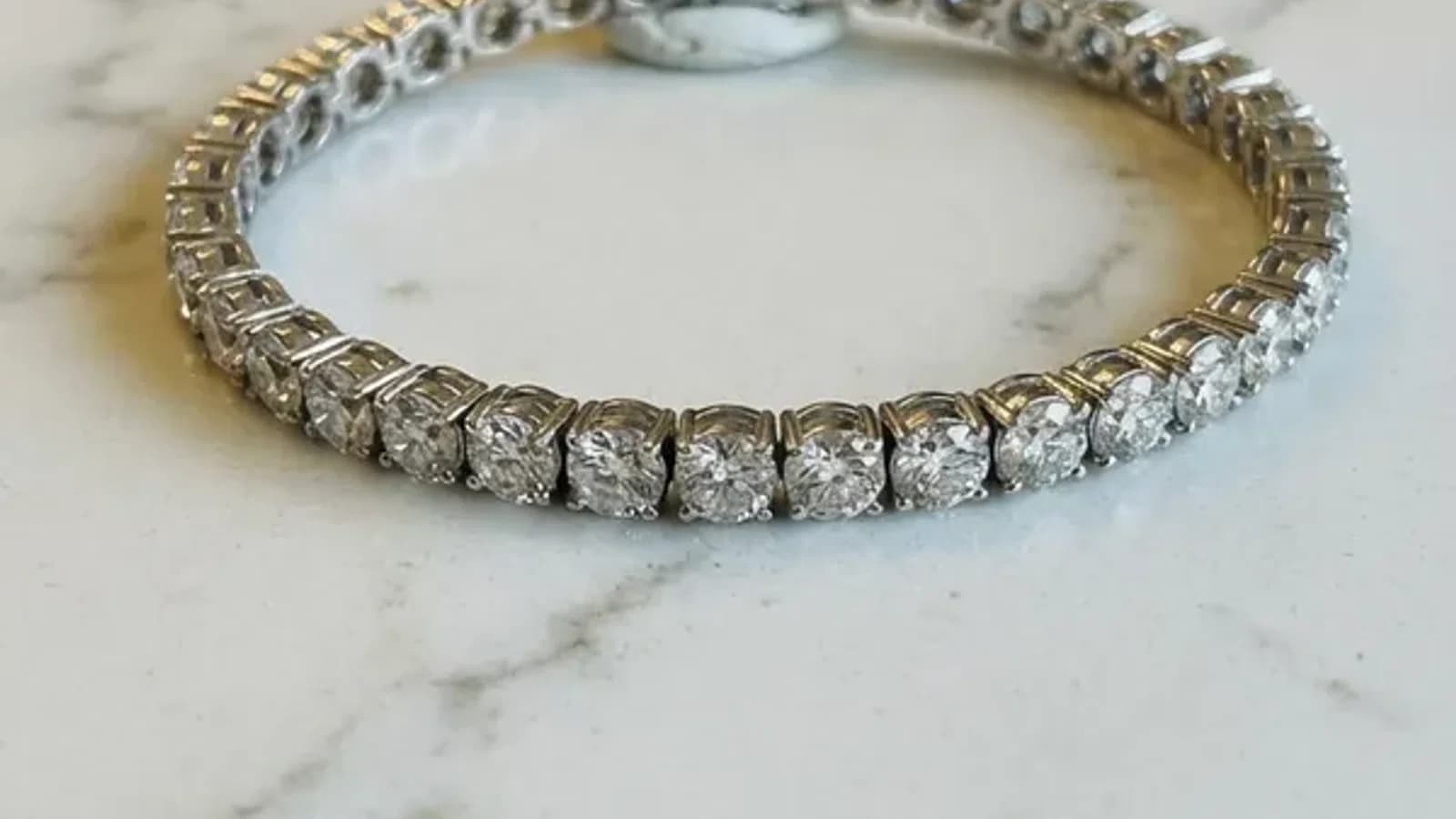 Comparison of AI-generated jewelry photo with plastic-looking metal versus properly retouched jewelry with natural reflections
